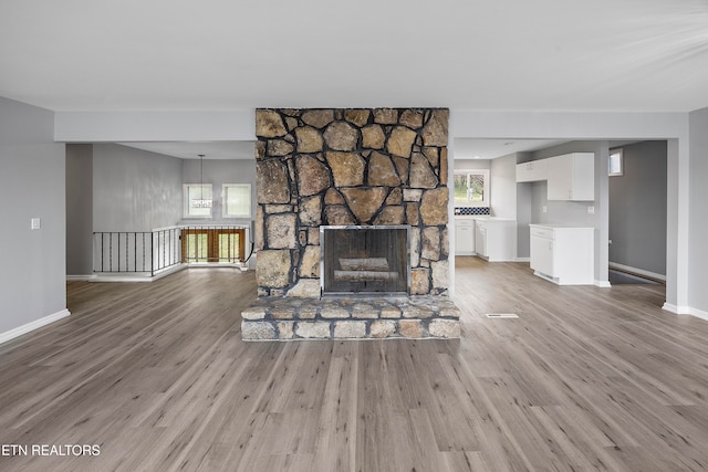 unfurnished living room with light wood-type flooring and a fireplace