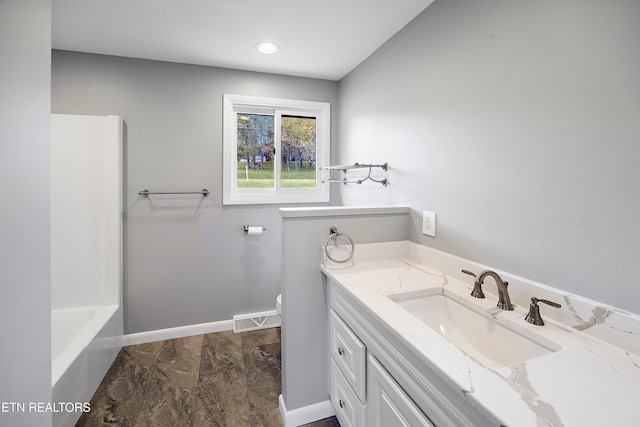 bathroom featuring vanity and a bath