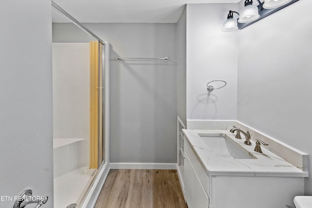 bathroom with vanity, a shower with shower door, wood-type flooring, and toilet