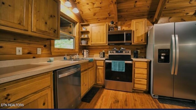 kitchen with light hardwood / wood-style floors, stainless steel appliances, wooden ceiling, beam ceiling, and sink