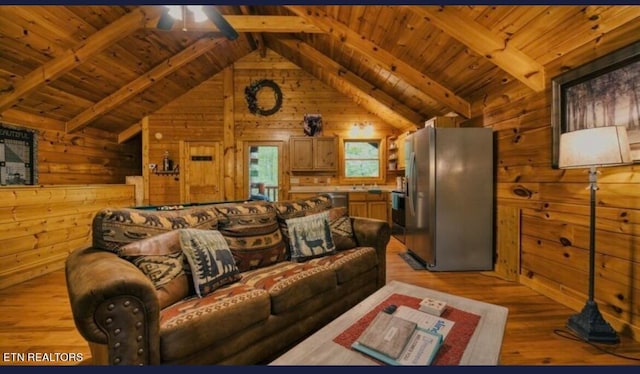 living room featuring ceiling fan, wood ceiling, wooden walls, lofted ceiling with beams, and light hardwood / wood-style floors