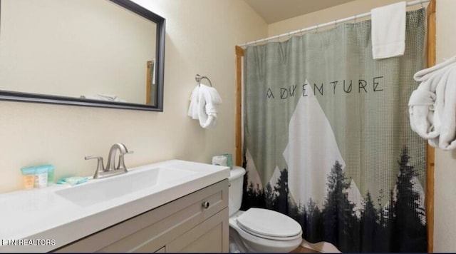 bathroom featuring vanity and toilet