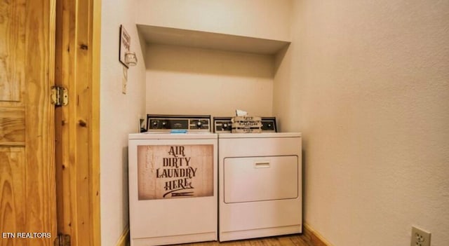 clothes washing area with light hardwood / wood-style flooring and washing machine and dryer