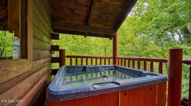 wooden terrace featuring a hot tub