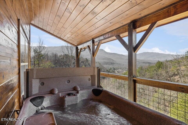 exterior space featuring a mountain view, lofted ceiling, and wood ceiling