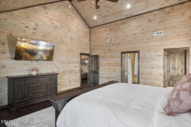 bedroom with wooden walls, dark wood-type flooring, and high vaulted ceiling