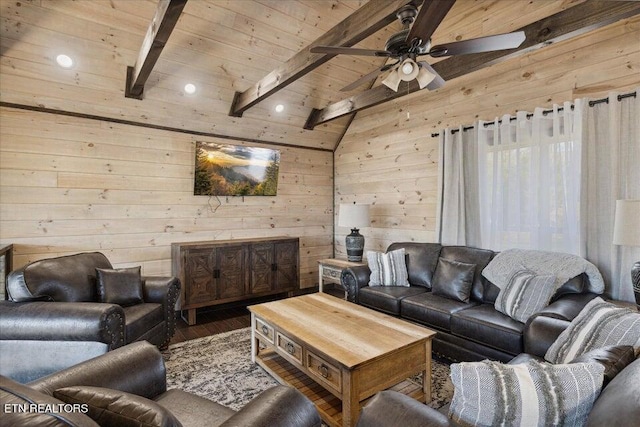 living room with lofted ceiling with beams, wood-type flooring, wood ceiling, wooden walls, and ceiling fan