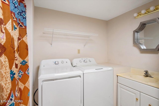 washroom featuring cabinets, separate washer and dryer, and sink