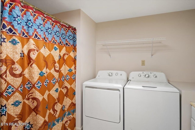 washroom with washing machine and clothes dryer