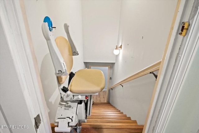 stairs featuring wood-type flooring