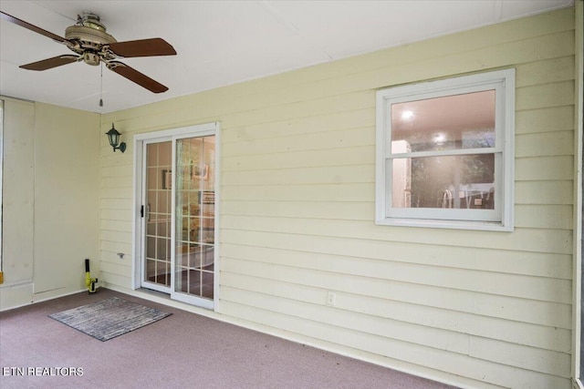 exterior space with ceiling fan