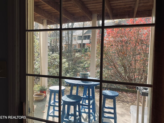 unfurnished sunroom with beamed ceiling and wooden ceiling