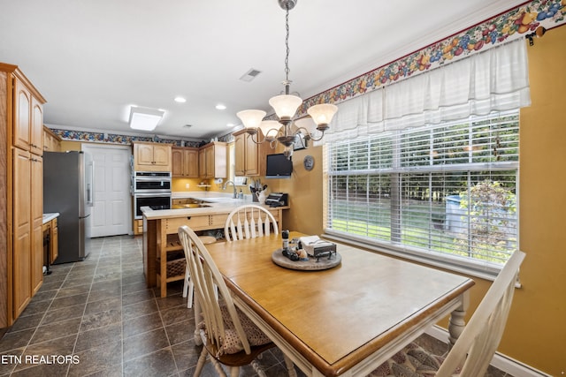 dining room with an inviting chandelier and sink