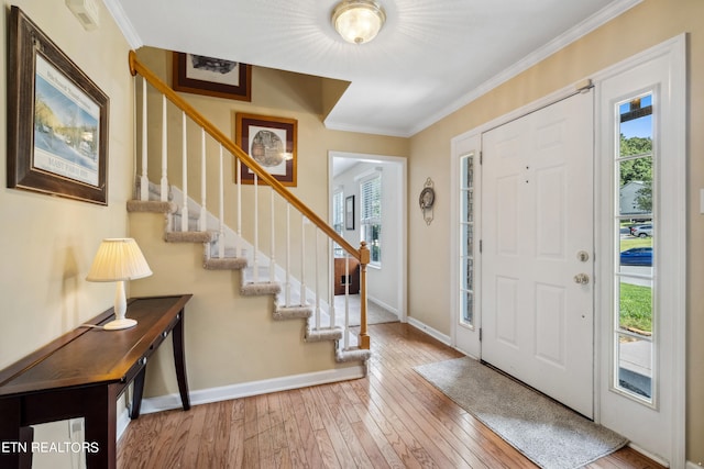 entrance foyer with wood-type flooring and crown molding