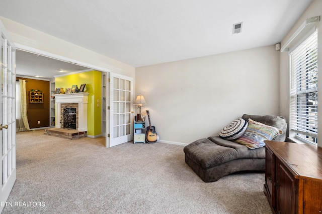 living area featuring light carpet and french doors