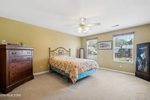 bedroom with light carpet and ceiling fan