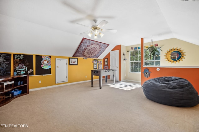 living area featuring carpet floors, vaulted ceiling, and ceiling fan