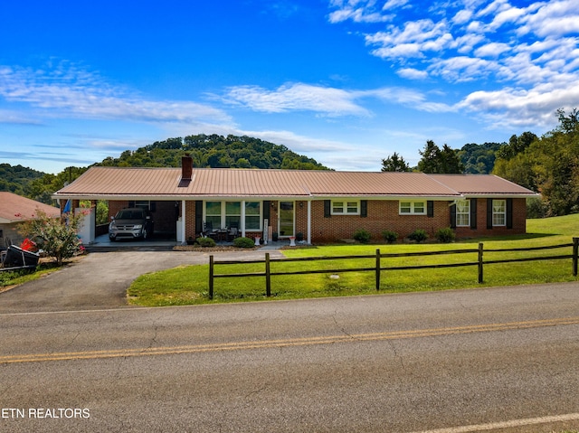 ranch-style house featuring a front yard and a carport