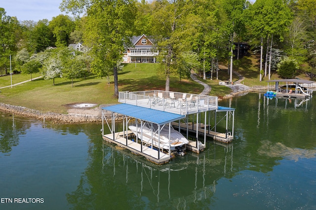 view of dock with a water view and a yard