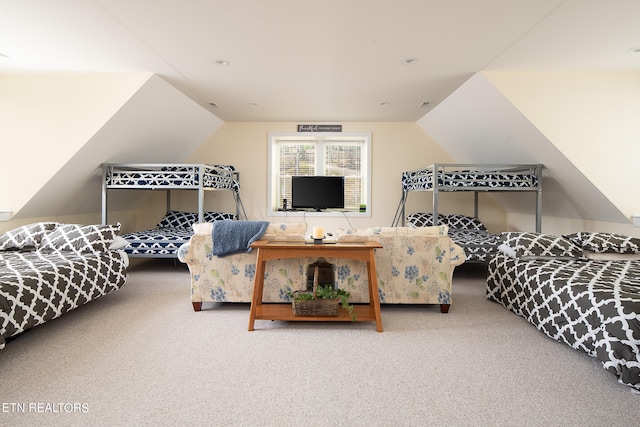 bedroom featuring lofted ceiling and carpet