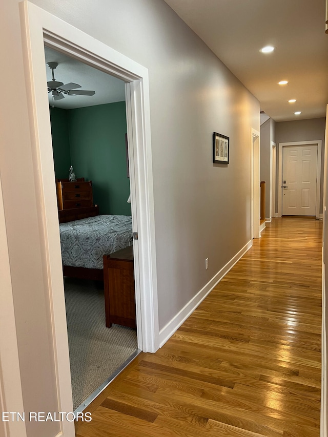 corridor with wood-type flooring