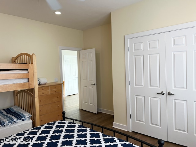 bedroom featuring a closet, ceiling fan, and dark hardwood / wood-style floors