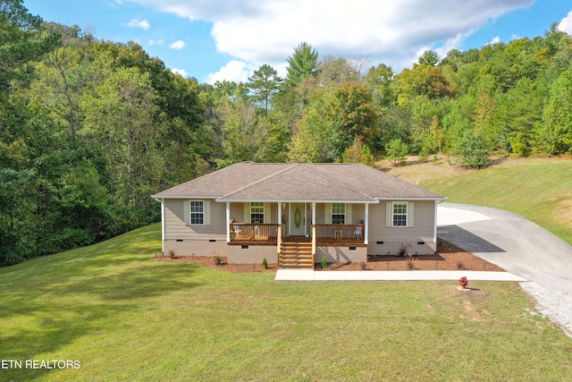 view of front of house with a front yard and covered porch