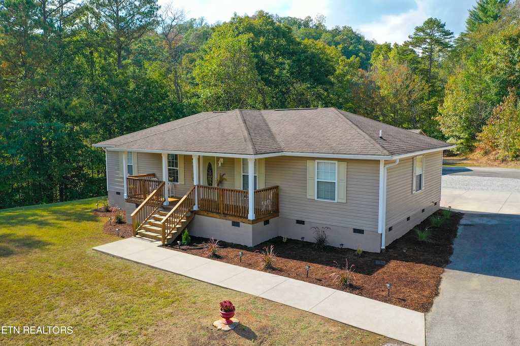 view of front of home with a porch and a front lawn