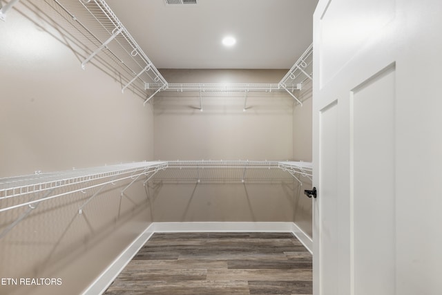 spacious closet featuring hardwood / wood-style flooring