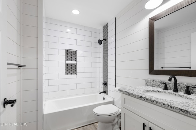 full bathroom featuring vanity, toilet, and tiled shower / bath