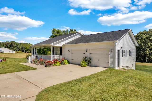 ranch-style house with covered porch, a garage, and a front yard