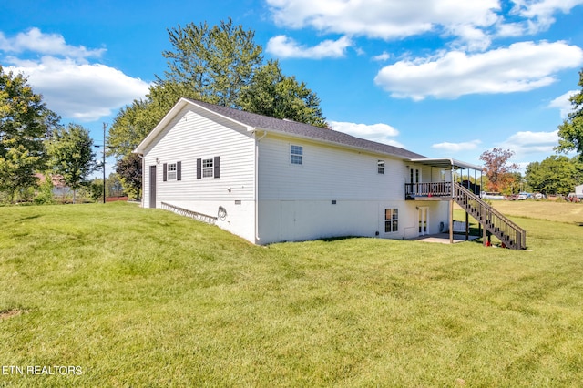 back of house with a wooden deck and a lawn