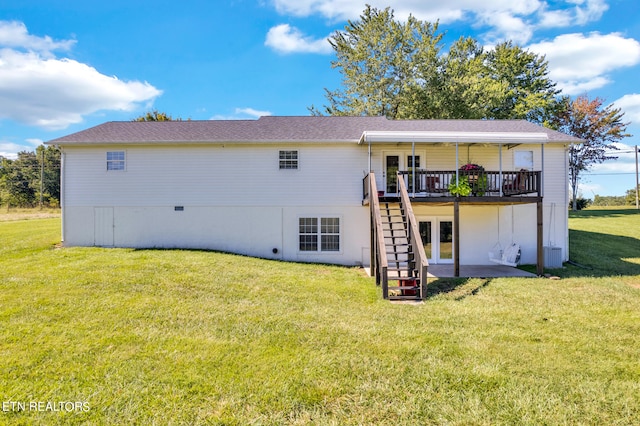 rear view of house featuring a yard and a wooden deck