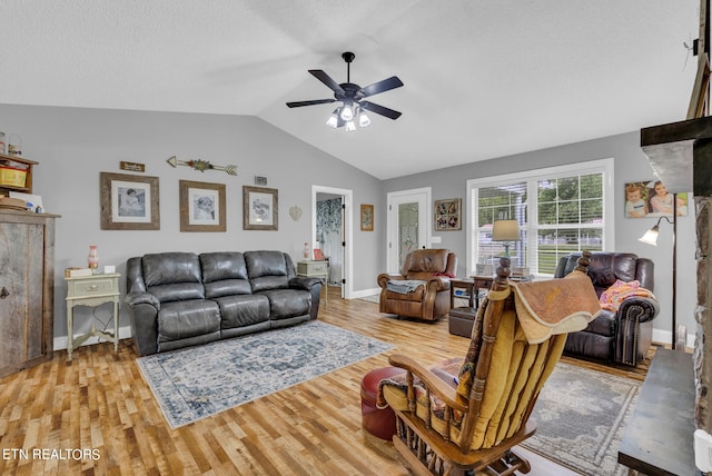 living room featuring hardwood / wood-style floors, ceiling fan, and lofted ceiling