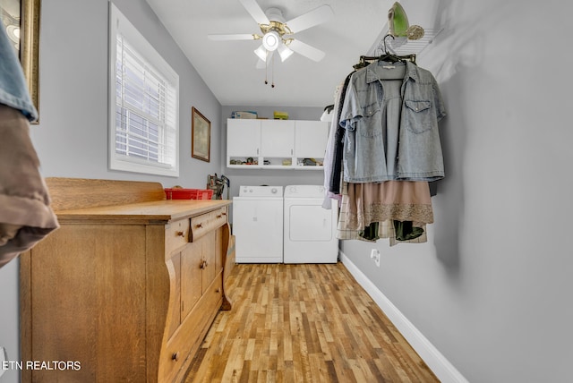 clothes washing area featuring ceiling fan, cabinets, light wood-type flooring, and washing machine and clothes dryer