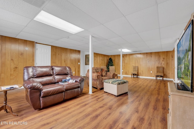 living room featuring a paneled ceiling and hardwood / wood-style floors