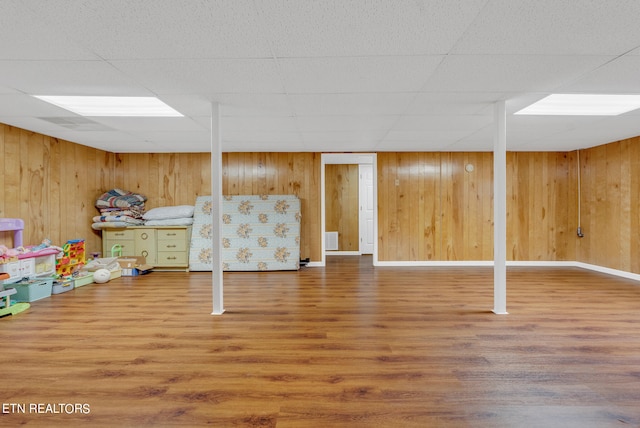 interior space with hardwood / wood-style floors and a drop ceiling