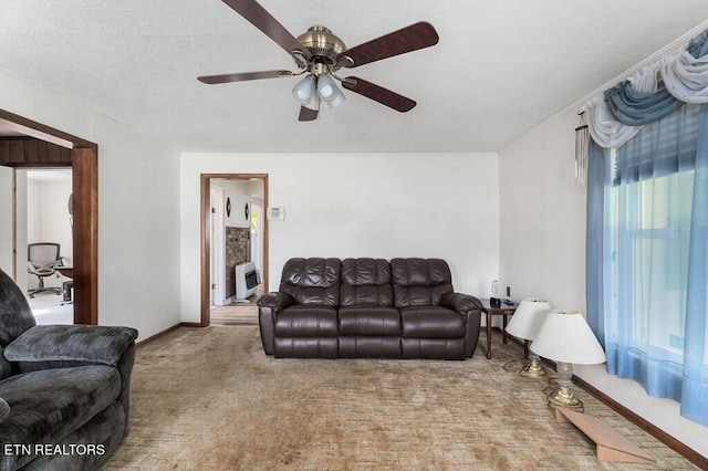 living room with ceiling fan, heating unit, light carpet, and a textured ceiling