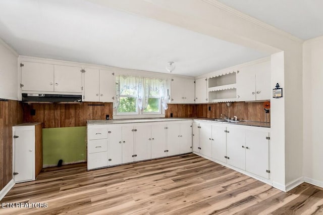 kitchen featuring light hardwood / wood-style flooring, white cabinets, sink, and crown molding