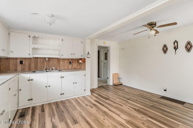 kitchen featuring light hardwood / wood-style floors, white cabinetry, and ceiling fan