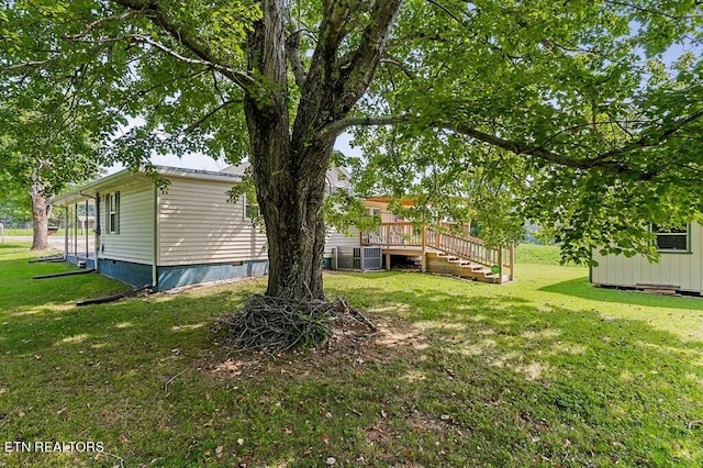 view of yard with cooling unit and a deck