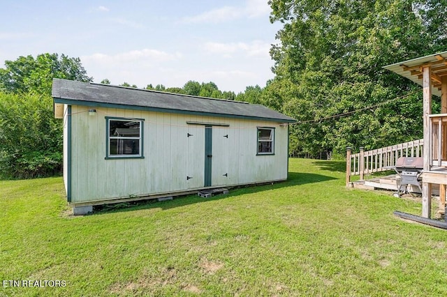 view of outbuilding with a lawn