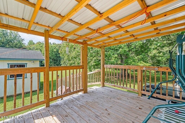 wooden terrace featuring a yard