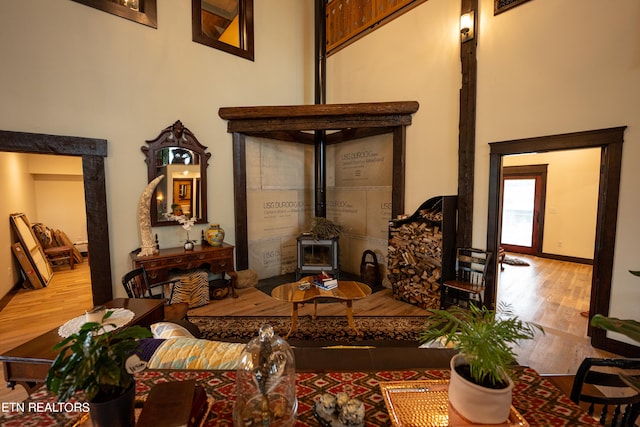 sitting room with light hardwood / wood-style floors and a wood stove