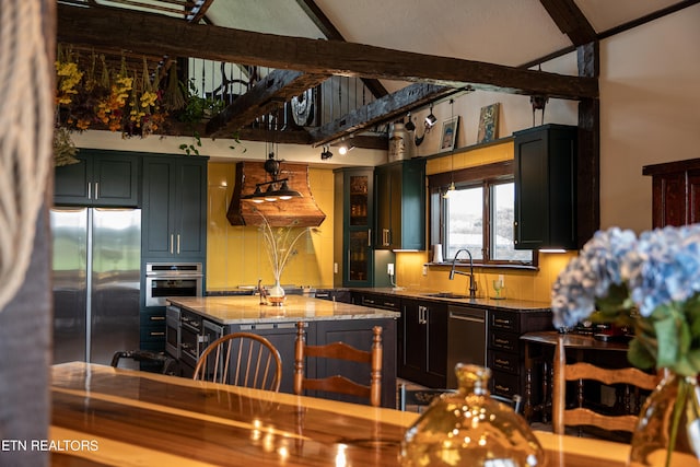 kitchen with sink, a center island, a kitchen breakfast bar, stainless steel appliances, and light stone counters