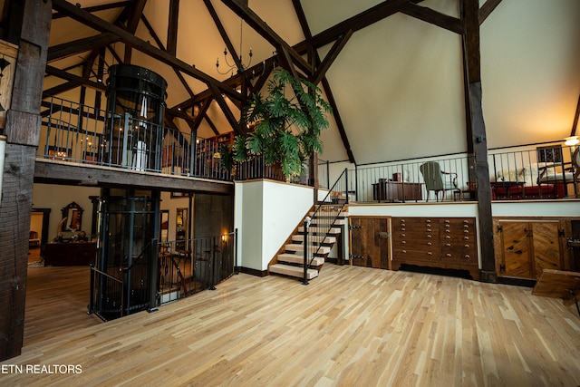 interior space featuring high vaulted ceiling and hardwood / wood-style floors