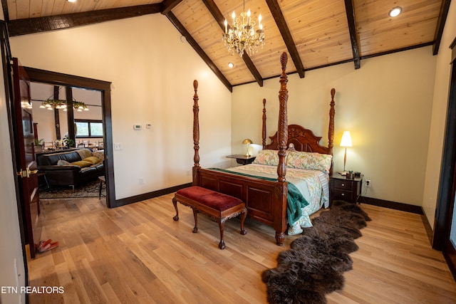 bedroom with beamed ceiling, light hardwood / wood-style flooring, an inviting chandelier, and wooden ceiling