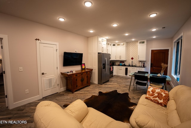 living room featuring dark wood-type flooring and sink