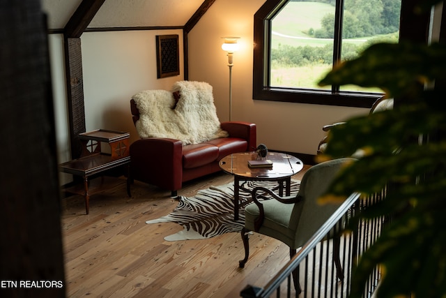 sitting room with ornamental molding and hardwood / wood-style flooring