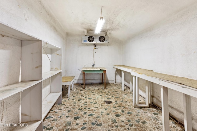 office space with a workshop area and stone finish flooring